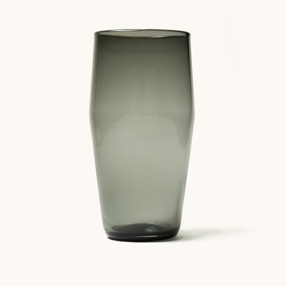 Smoky grey Standard Pint Glass with a tapered shape and dark glass bottom, isolated on white.