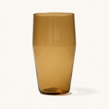 Amber tinted standard pint glass with textured base, front view, clear glassware design