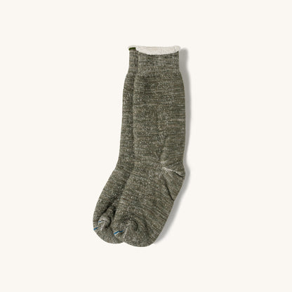 Army green double face tabi crew socks with ribbed cuff and split toe, shown flat on cream background.