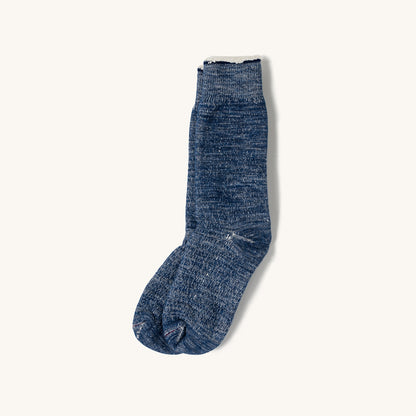 Deep ocean blue double face crew socks with a textured heathered knit and ribbed white cuff, shown in side view.