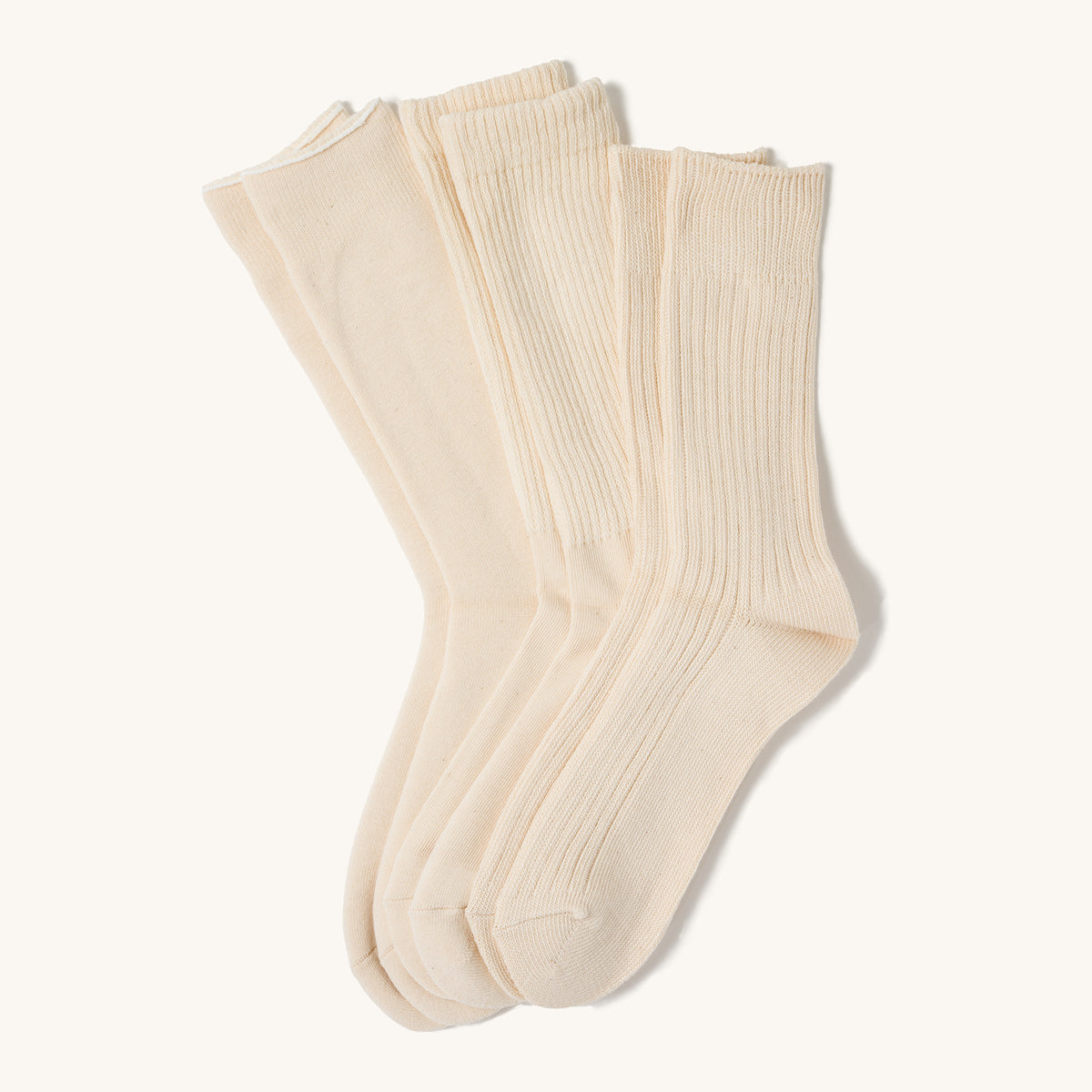 Ecru crew socks in a 3-pack with ribbed cuffs, displayed side-by-side on a plain white background.