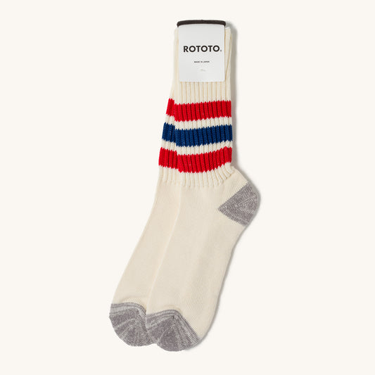 Cream coarse ribbed crew socks by Rototo with red and blue stripes, grey heel and toe.