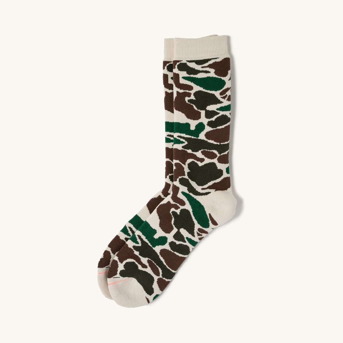 Ivory pile camo crew socks with brown and green pattern, ribbed cuff, and pink toe seam on white background.