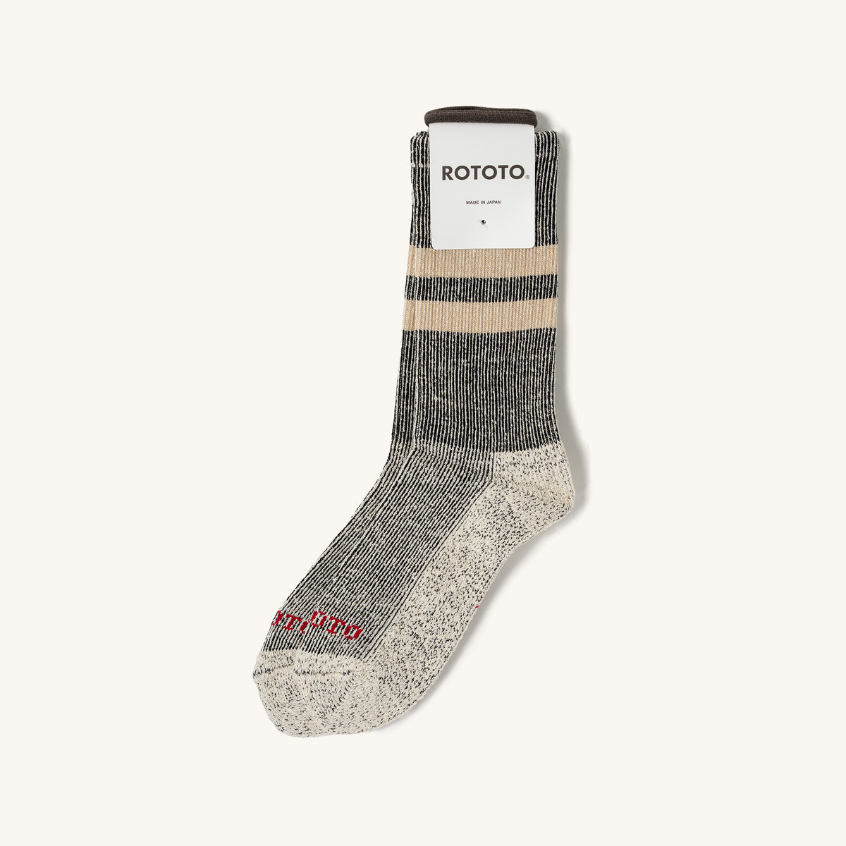 Black and beige marl stripe socks by Rototo, with a brown cuff, speckled heel, and red toe text.