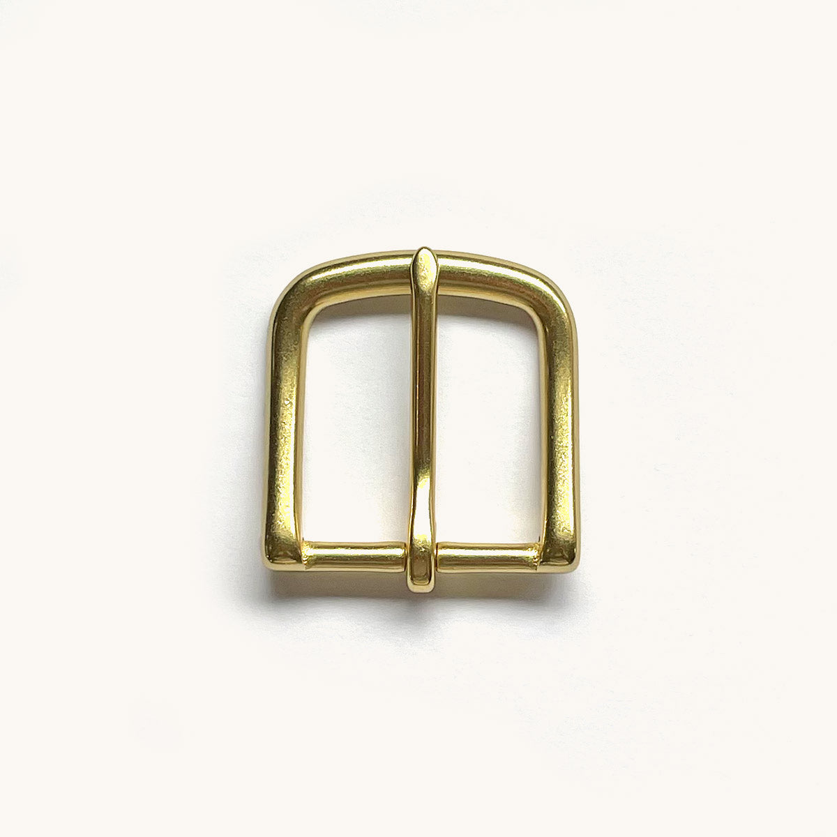 Natural brass Classic Belt buckle with rounded edges, displayed on a white surface.