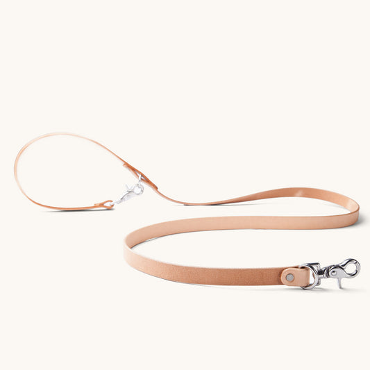 Convertible Canine Lead in natural leather with silver-tone swivel clasps and a rivet.