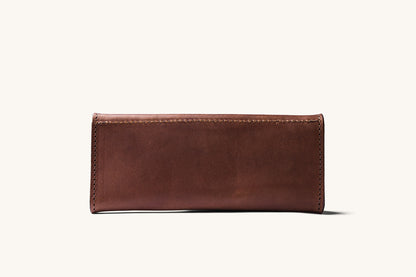 Cognac leather wallet with visible stitching on all edges, presented horizontally.